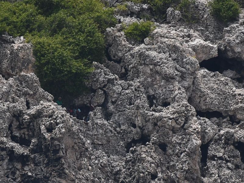 US Coast Guard rescue boat approaching migrants on cliffs in the Mona Passage off Puerto Rico