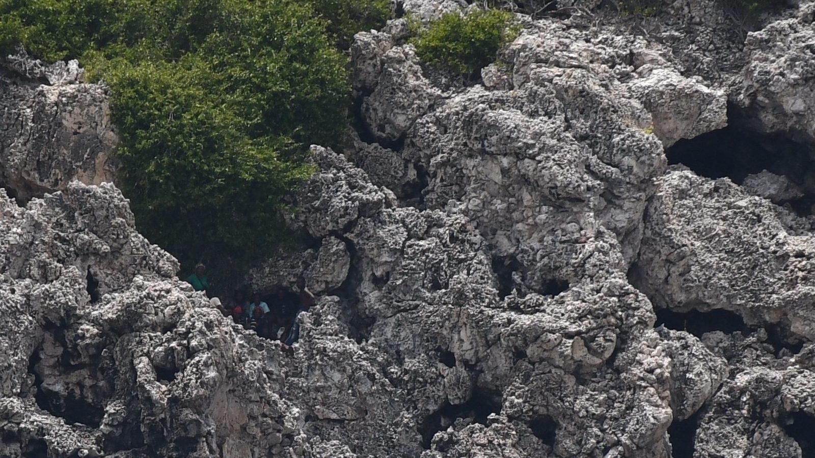 US Coast Guard rescue boat approaching migrants on cliffs in the Mona Passage off Puerto Rico