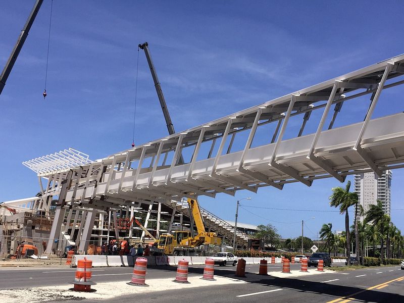 Cranes and a steel pedestrian bridge under construction on Avenida Muñoz Rivera in Hato Rey, San Juan