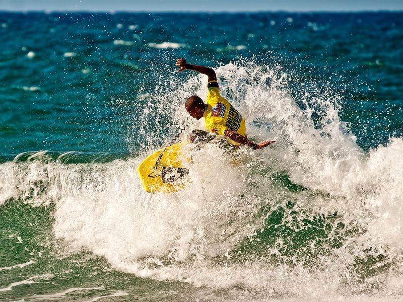 Surfer riding a wave at Hallows Beach in Arecibo, Puerto Rico