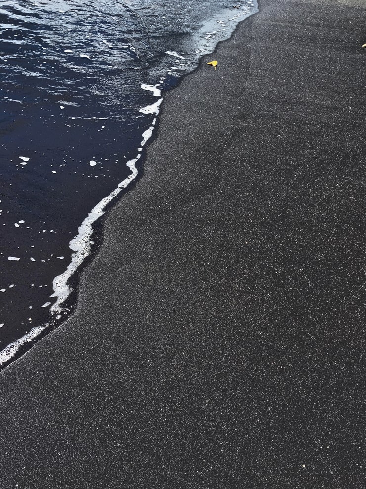 image of black sand shoreline