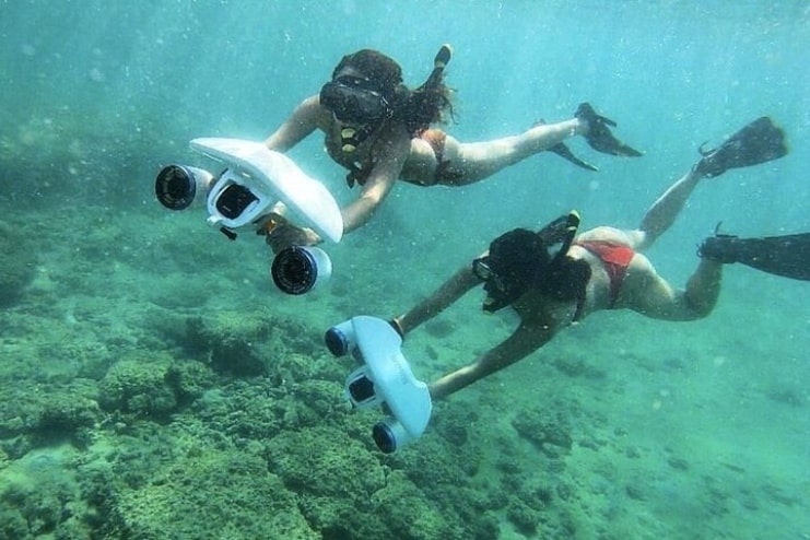 image of two person snorkel under the ocean