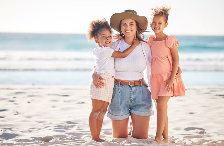 portrait of a mother and children on sand