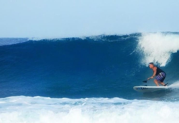 image of a guy surfing in Wilderness