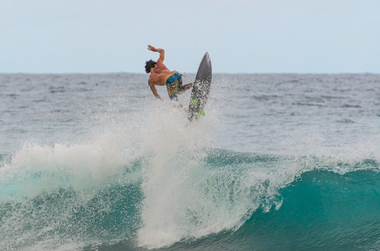 image of a man surfing