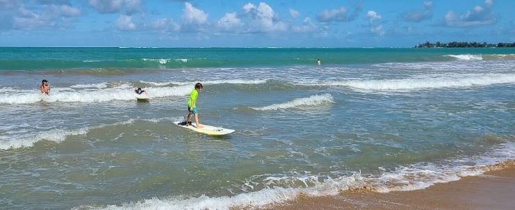 image showing a kid learning how to surf