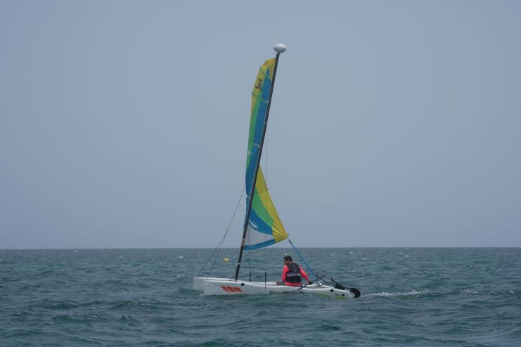 image of a man sailing a hobie cat