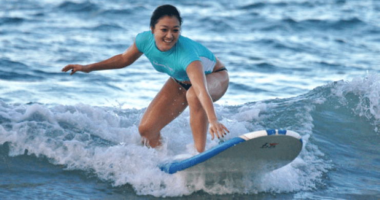 image of a woman surfing