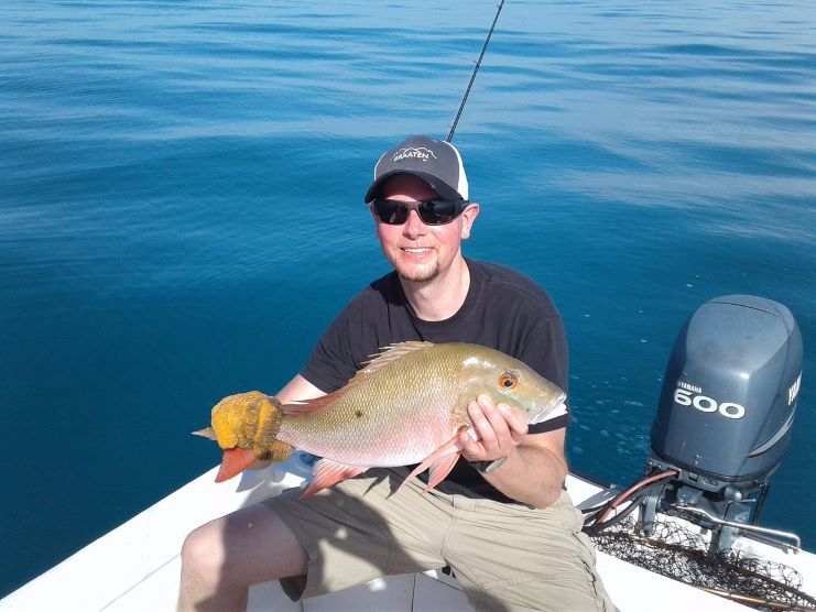 image showing a guy catches a fish