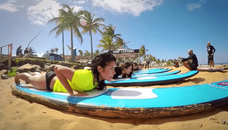 image of women doing a surfing class