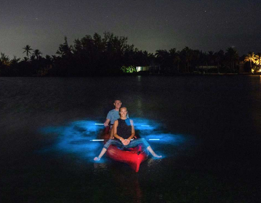 a man and a woman sitting on a kayak in the water